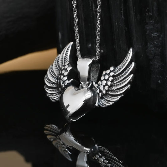 Colgante detente corazon con alas en plata 950